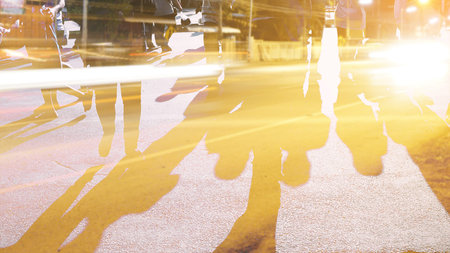 People walking on the pedestrian crossing in motion blur.の写真素材