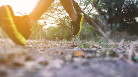 Athlete runner feet running on trail. Close up of trail running shoe. blurred sport backgroundの写真素材