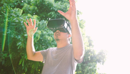 Young man wearing virtual reality glasses. Virtual reality concept, Smartphone and VR headset の写真素材
