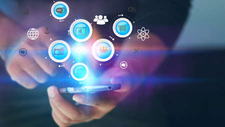 Hand touch screen smart phone, icons interface on screen, Social media, connect to the future concept.の写真素材
