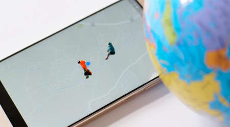 Miniature traveler walking on world map. Travel concept.の写真素材