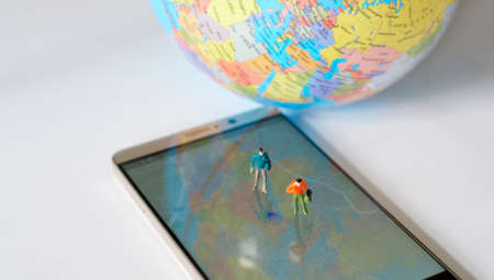Miniature traveler walking on world map. Travel concept.の写真素材