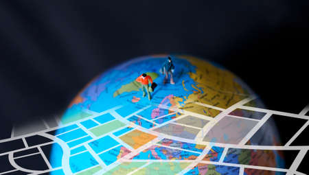 Miniature traveler walking on globe. Travel concept.の写真素材