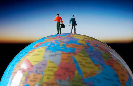 Miniature traveler walking on globe. Travel concept.の写真素材