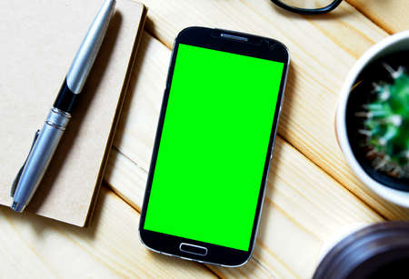Top view office desk with blank screen smartphone,  flat layの写真素材