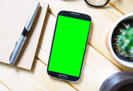 Top view office desk with blank screen smartphone,  flat layの写真素材