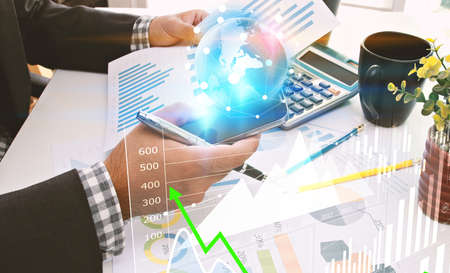 Businessman analysis financial paperwork and reports, graph, planning,working at office desk.の写真素材