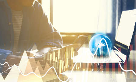 Businessman using smartphone and analysis diagram. Business graph background. financial graphの写真素材