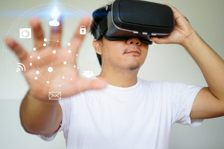 Young man wearing virtual reality glasses and touching on virtual screen. Virtual reality concept   の写真素材