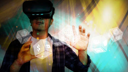 Young man wearing virtual reality glasses and touching on virtual screen. Virtual reality concept   の写真素材