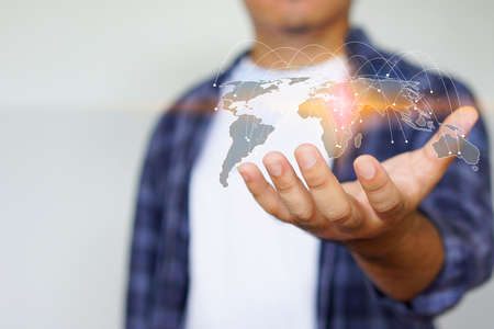 Young man holding world map symbol. social network concept  の写真素材
