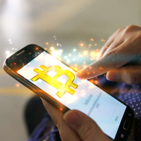 bitcoin on smartphone screen for online payment . digital currency, e-Money, Financial Internet Technology Concept.の写真素材