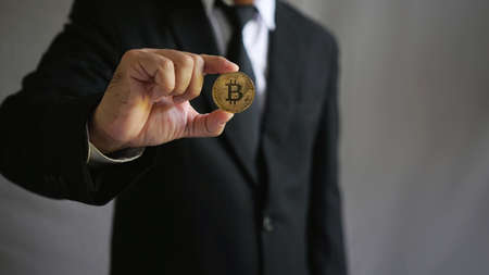 Businessman holding bitcoin symbol.                               の写真素材