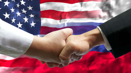 Businessman shake hand over United States of America and Russia flag.の写真素材