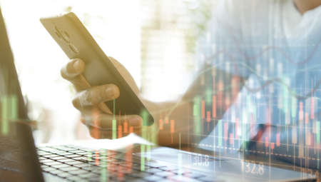 Businessman working on smartphone and analysis stock chart. Business growth conceptの写真素材