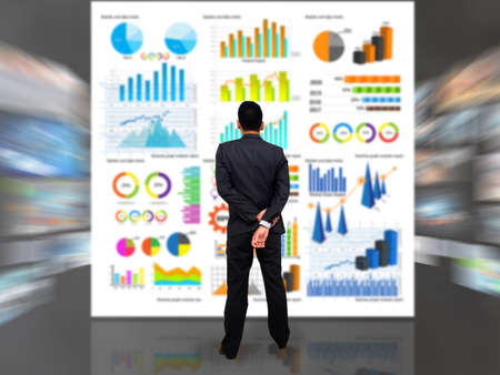 businessman thinking about decisions with financial graph backgroundの写真素材