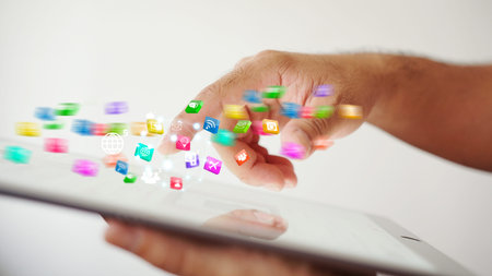 hand presses social media icons on screen digital tablet modern technology as social media...