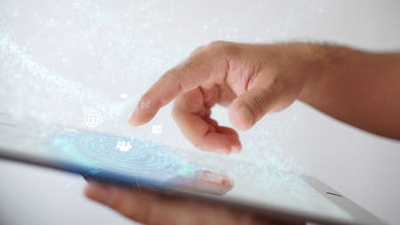 hand holding tablet with social icons. Globalization businessの写真素材