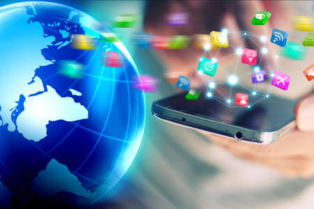 Businessman holding glowing globe with Social media icons.
の写真素材