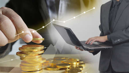 Businessman analysis stock exchange market with Money coins and financial graph. Business Growth conceptの写真素材