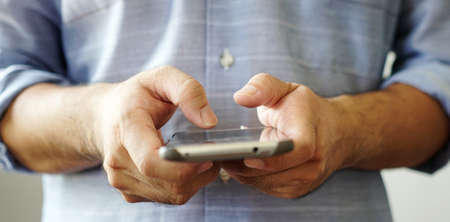 Hand using smartphone connecting to internet.の写真素材