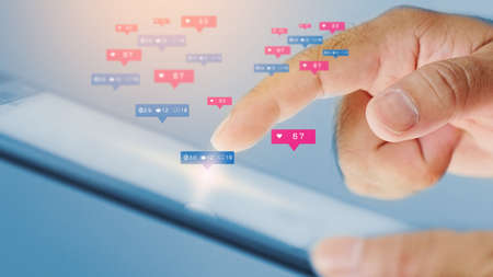 Businessman using digital tablet with social icons on screenの写真素材