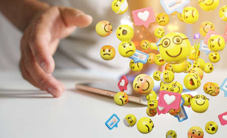 Man using smartphone sending text messages emoticon icons. social media concept, 3d renderingの写真素材