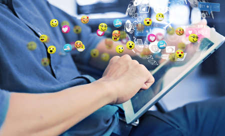 Man using smartphone sending text messages emoticon icons. Social network concept, 3d renderingの写真素材