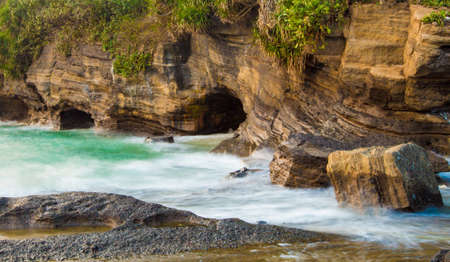 Waves hitting the rocksの写真素材