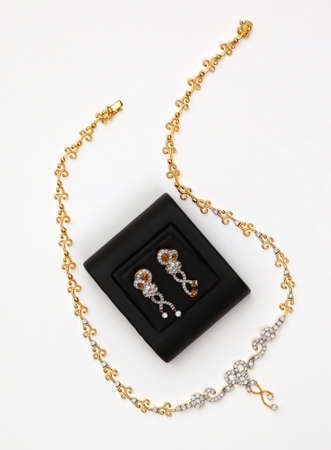 Diamond earring, golden necklace with diamond, isolated on white background. の写真素材