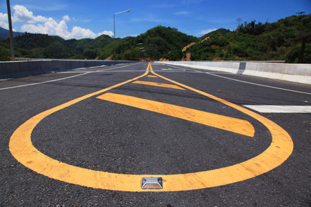 Yellow line on highway with mountain view and blue sky