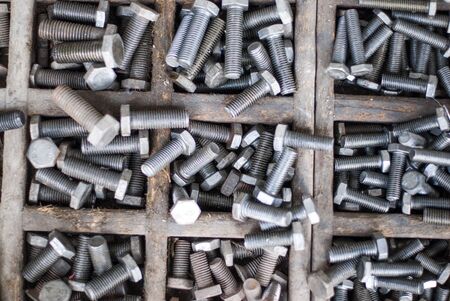 Closeup on metal bolts in containerの写真素材