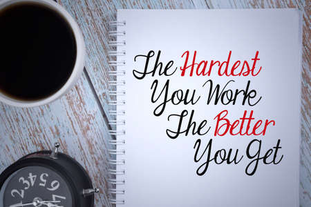 The Hardest You Work The Better You Get wording with selective focus image of a cup of coffee and clock. Business and motivational conceptの写真素材