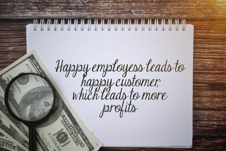 Selective focus image of bank note and magnifying glass with Happy employees leads to happy customer...