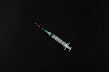 Selective focus image of syringe on black background