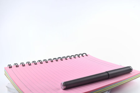Selective focus image of spectacles and notebook on a white background with copy space. Conceptual...