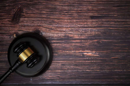 Selective focus image of gavel isolated over a wooden background. Law conceptの写真素材