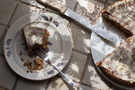 sliced carrot cake, served on a ceramic plate with decor