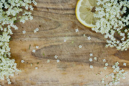 preparation of elderberry juice, ingredients of elderflower and lemon, preparation on the old tableの写真素材