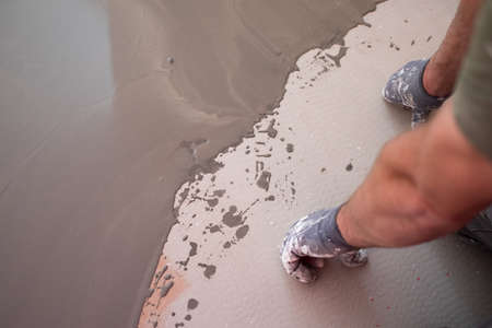 self-leveling concrete on the old floor, reconstruction process, orange brick floor inside the old historic house, close-up viewの写真素材