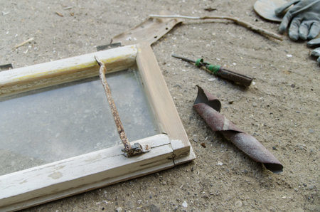 sanding wooden window in workshop, close up. View of tools during work