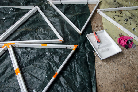 painting on a white wooden structure for a greenhouse, close up