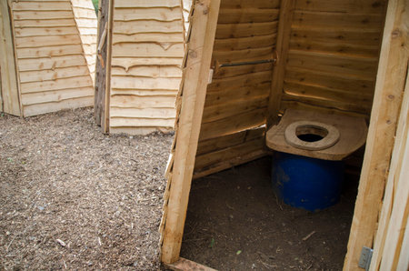 Wooden ecological composting toilet on countryside, several wooden toilets