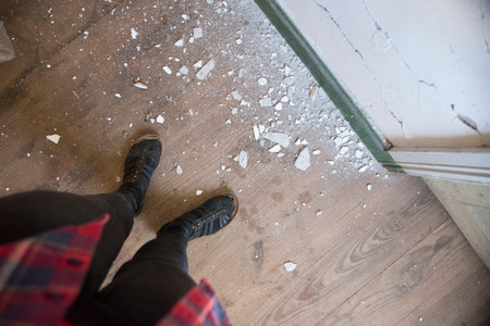 Apartment interior renovation. Old wallpaper partially scraped off. Scrap of wallpaper in the old...