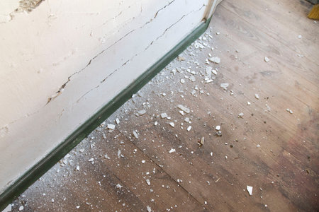 Apartment interior renovation. Old wallpaper partially scraped off. Scrap of wallpaper in the old...