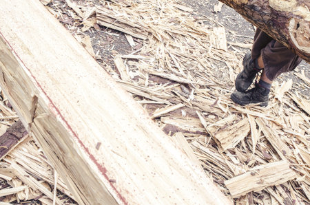detail of beam, modified by traditional carpentry technique only with ax, wooden chips, view of legs