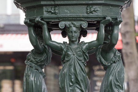 Caryatids women of a fountain in Paris, France, summer time