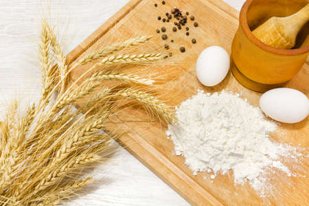 Spagetti on wood plate with eggs and saltの写真素材