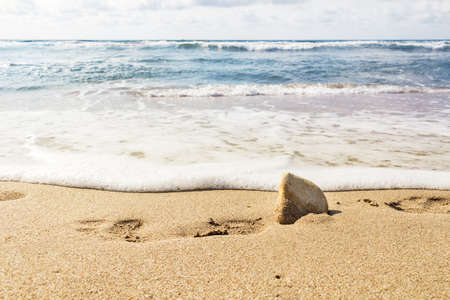 footsteps on a sand beachの写真素材