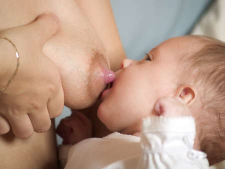 mother breast feeding her newborn babyの写真素材